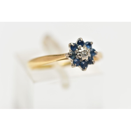 43 - A YELLOW METAL DIAMOND AND SAPPHIRE CLUSTER RING, the brilliant cut diamond centre with circular cut... 