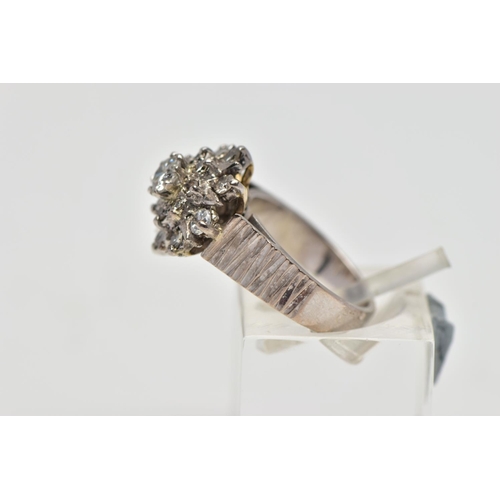 5 - A WHITE METAL DIAMOND FLORAL CLUSTER RING, comprising a brilliant cut central diamond with single cu... 