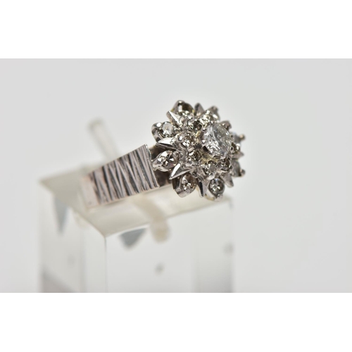 5 - A WHITE METAL DIAMOND FLORAL CLUSTER RING, comprising a brilliant cut central diamond with single cu... 