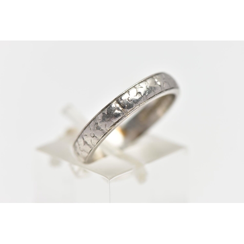 50 - A WHITE METAL BAND RING, decorated with a slightly worn floral pattern, stamped 'HA Platinum', ring ... 