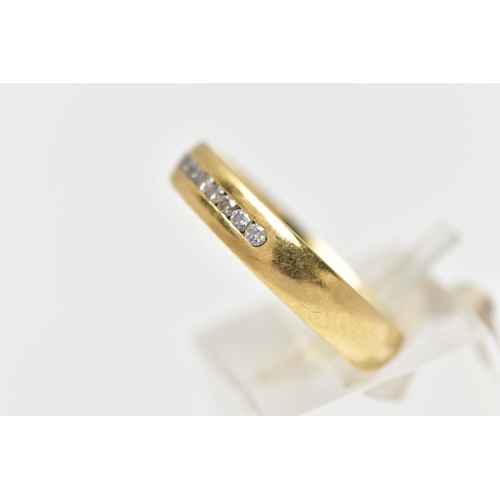 57 - AN 18CT YELLOW GOLD DIAMOND BAND RING, set with a line of eleven round brilliant cut diamonds, chann... 