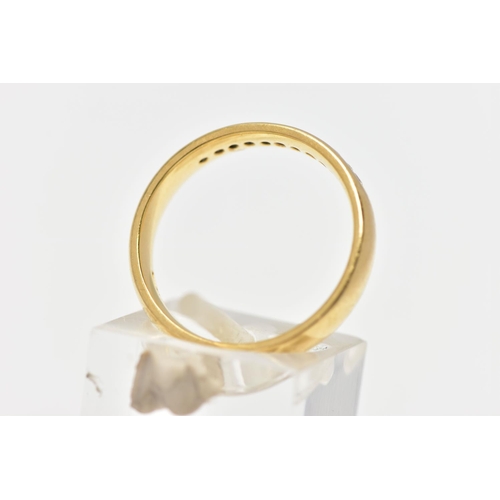 57 - AN 18CT YELLOW GOLD DIAMOND BAND RING, set with a line of eleven round brilliant cut diamonds, chann... 