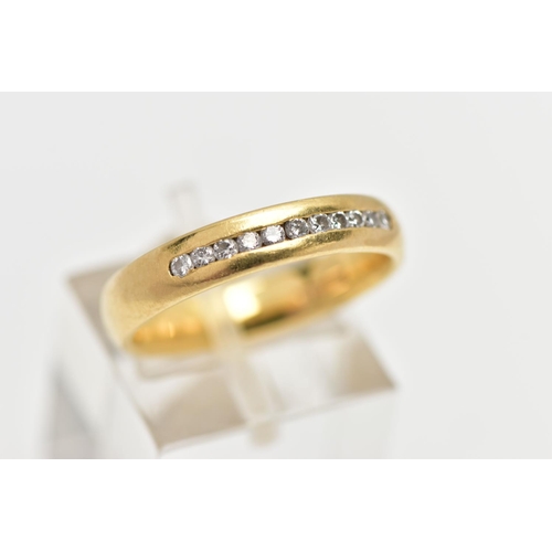 57 - AN 18CT YELLOW GOLD DIAMOND BAND RING, set with a line of eleven round brilliant cut diamonds, chann... 