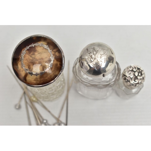 71 - A SELECTION OF GLASS BOTTLES WITH SILVER LIDS AND STICK PINS, to include an early 20th century textu... 