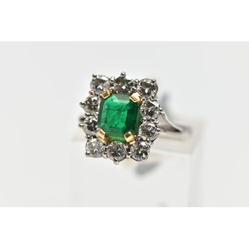 9 - AN 18CT WHITE AND YELLOW GOLD EMERALD AND DIAMOND CLUSTER RING, the rectangular cut emerald, within ... 