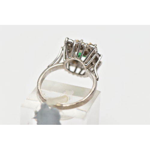 9 - AN 18CT WHITE AND YELLOW GOLD EMERALD AND DIAMOND CLUSTER RING, the rectangular cut emerald, within ... 