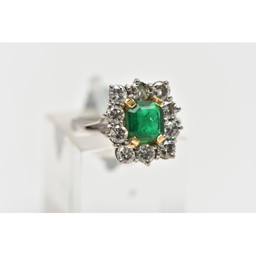 9 - AN 18CT WHITE AND YELLOW GOLD EMERALD AND DIAMOND CLUSTER RING, the rectangular cut emerald, within ... 