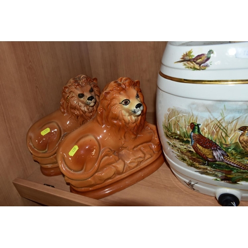 435 - ONE PAIR AND TWO SIMILAR STAFFORDSHIRE RECUMBENT LIONS TOGETHER WITH A CERAMIC BEER BARREL decorated... 