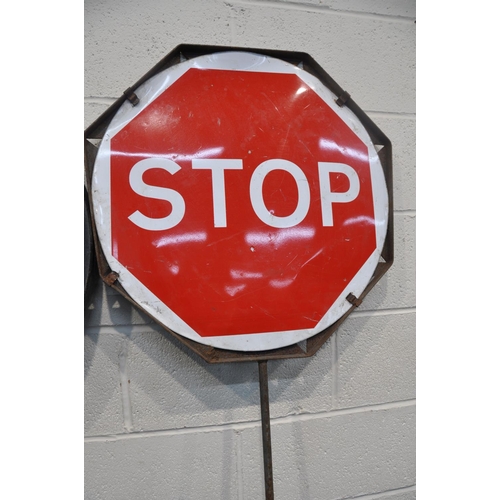 1083 - TWO VINTAGE STOP AND GO SIGNS comprising a steel sign and another plastic stop and go sign, along wi... 