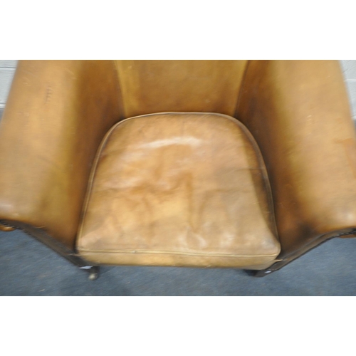 1323 - A TANNED LEATHER TUB CHAIR, on front square tapering legs, with brass casters, width 87cm x depth 82... 