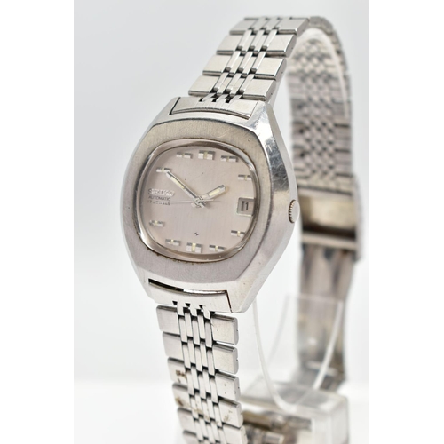 18 - A WHITE METAL SEIKO WRISTWATCH, the oval grey dial, with baton hourly markers, date window at three ... 