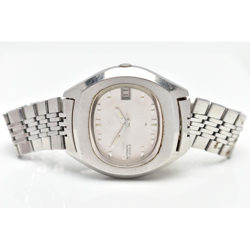 18 - A WHITE METAL SEIKO WRISTWATCH, the oval grey dial, with baton hourly markers, date window at three ... 