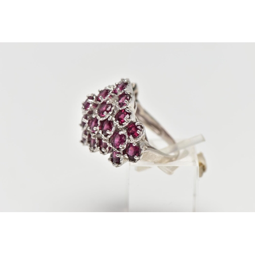 21 - A SILVER TOURMALINE COCKTAIL RING, designed as a cluster of raised circular cut pink tourmalines, cl... 