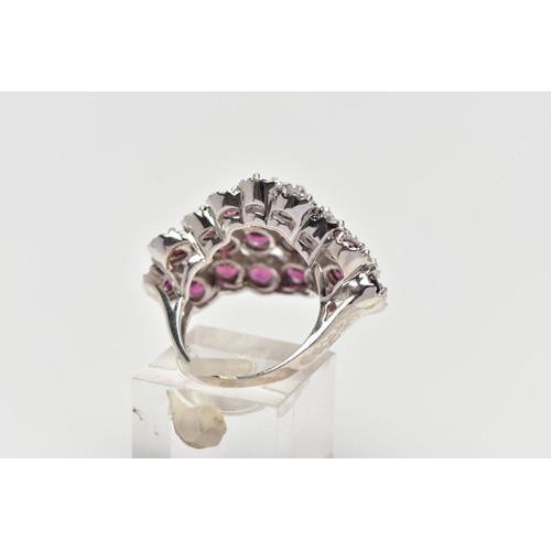 21 - A SILVER TOURMALINE COCKTAIL RING, designed as a cluster of raised circular cut pink tourmalines, cl... 