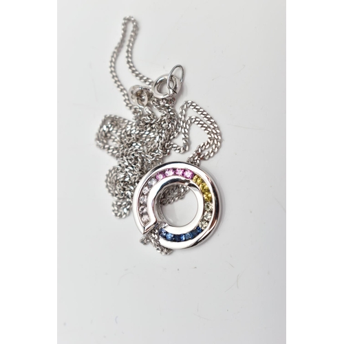 26 - A 9CT WHITE GOLD SAPPHIRE DISC PENDANT WITH 9CT GOLD CHAIN, the vary hue circular cut sapphires chan... 