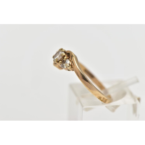 5 - A 9CT GOLD DIAMOND THREE STONE RING, comprising three graduated brilliant cut diamonds, to the asymm... 