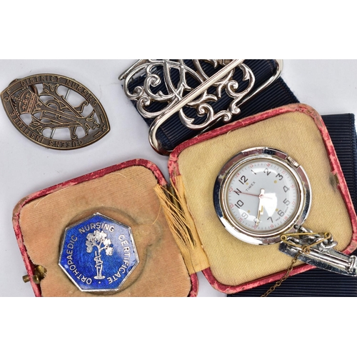 51 - A SILVER NURSES BELT BUCKLE AND NURSING BADGES, a silver open work belt buckle fitted to a stretch b... 