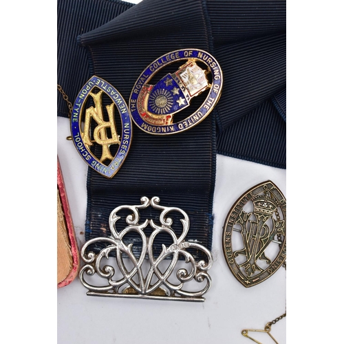 51 - A SILVER NURSES BELT BUCKLE AND NURSING BADGES, a silver open work belt buckle fitted to a stretch b... 