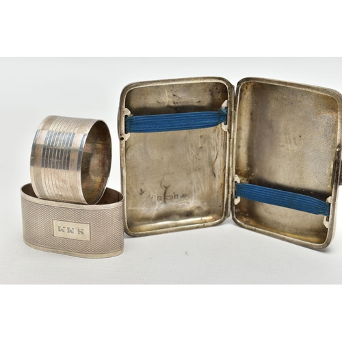 63 - A SILVER CIGARETTE CASE AND TWO NAPKIN RINGS, a rectangular form case, foliage engraving detail, mon... 