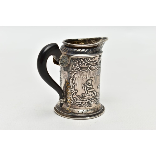 65 - AN EARLY 20TH CENTURY SILVER MILK JUG, of continental design, depicting mythical creatures/cherubs, ... 