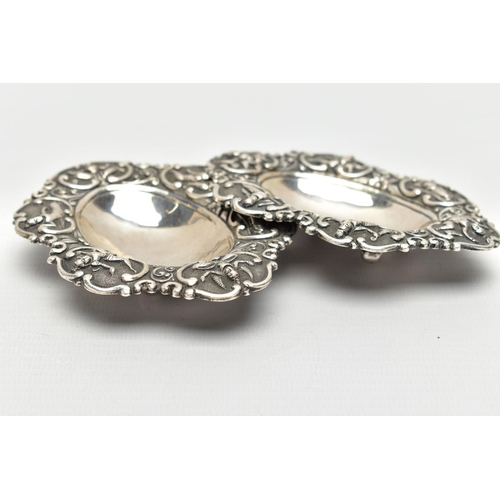 70 - TWO WHITE METAL BON BON DISHES, each dish embossed with Siam characters, to the concave centre and r... 