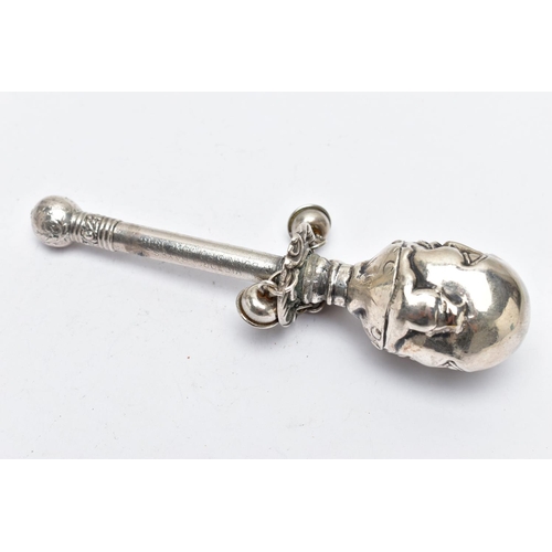 71 - A MID 19TH CENTURY WHITE METAL BABY RATTLE, depicting a character to the top, suspending three jingl... 