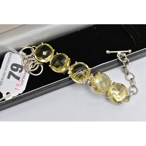 79 - A SILVER PALE YELLOW QUARTZ BRACELET, the bracelet comprising five circular cut pale yellow quartz c... 