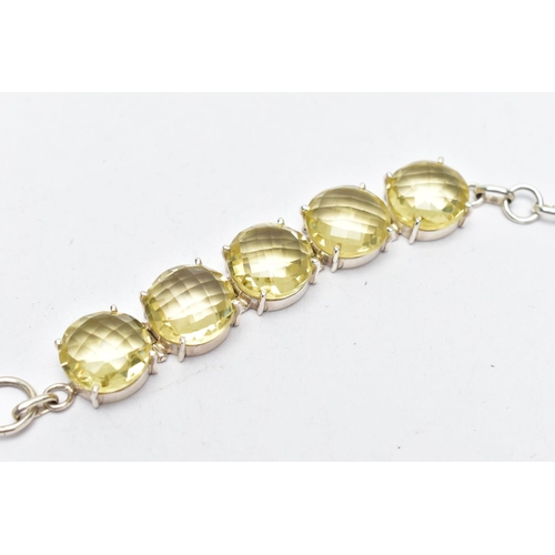 79 - A SILVER PALE YELLOW QUARTZ BRACELET, the bracelet comprising five circular cut pale yellow quartz c... 