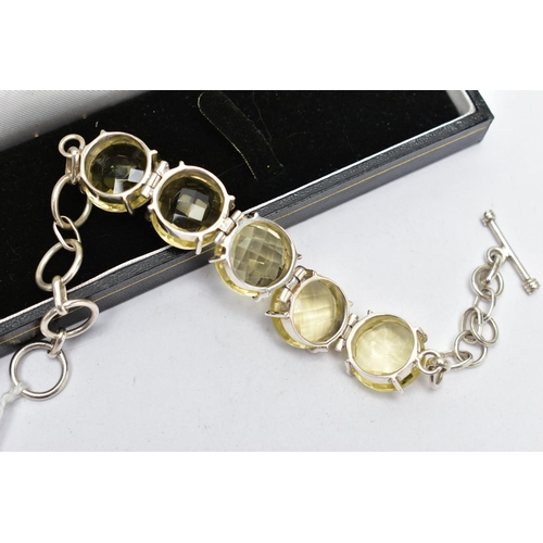 79 - A SILVER PALE YELLOW QUARTZ BRACELET, the bracelet comprising five circular cut pale yellow quartz c... 