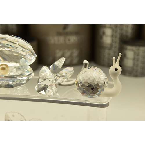 162 - ELEVEN BOXED SWAROVSKI CRYSTAL ORNAMENTS, from various collections, comprising Rose (174956) 1993 (E... 