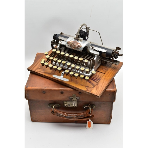 196 - AN EARLY 20TH CENTURY BLICK ALUMINIUM FEATHERWEIGHT TYPEWRITER IN A TAN LEATHER COVERED CASE, the re... 