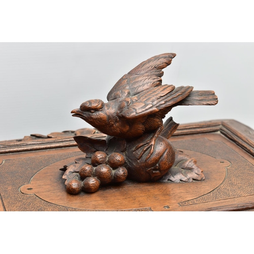 219 - A LATE 19TH CENTURY AND LATER BLACK FOREST CARVED AND STAINED WALNUT TANTALUS, carved surmount of a ... 