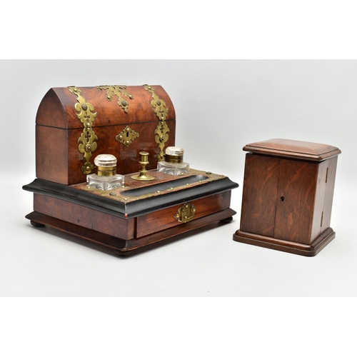 220 - A VICTORIAN BRASS MOUNTED WALNUT AND EBONISED DESKSTAND, fitted with an arched stationery box, two g... 