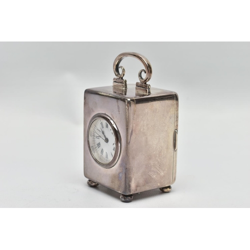 23 - AN EDWARDIAN WILLIAM COMYNS MINIATURE SILVER BOUDOIR CLOCK, the plain case with swing carrying handl... 