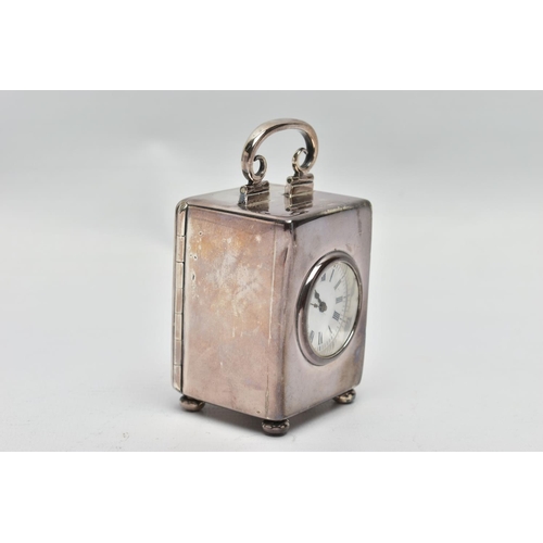 23 - AN EDWARDIAN WILLIAM COMYNS MINIATURE SILVER BOUDOIR CLOCK, the plain case with swing carrying handl... 