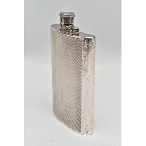 26 - AN ELIZABETH II SILVER HIP FLASK OF BOWED RECTANGULAR FORM, fitted with a hinged bayonet cap with co... 