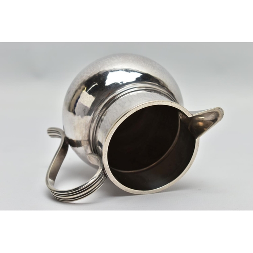 34 - A GEORGE V SILVER JUG OF SQUAT BALUSTER FORM, the S scroll reeded handle on a planished body, makers... 