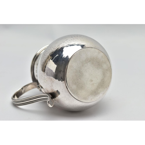 34 - A GEORGE V SILVER JUG OF SQUAT BALUSTER FORM, the S scroll reeded handle on a planished body, makers... 