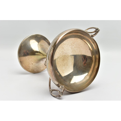 45 - A GEORGE V SILVER TWIN HANDLED TROPHY CUP, the shallow silver cup on a slender pedestal with cast sc... 