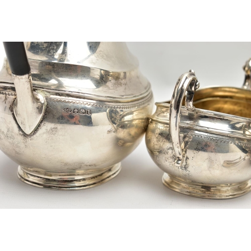 54 - A GEORGE V SILVER FOUR PIECE TEA SERVICE OF OVAL FORM, comprising tea pot, hot water/coffee jug, mil... 