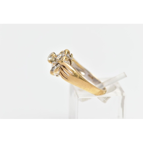 7 - A MODERN YELLOW METAL DIAMOND CLUSTER RING, set with a principal round brilliant cut diamond, within... 