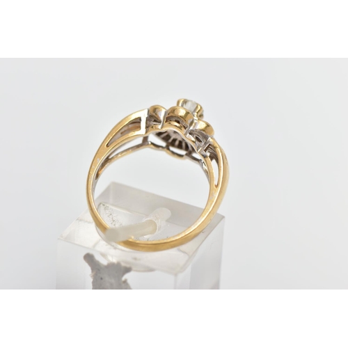 7 - A MODERN YELLOW METAL DIAMOND CLUSTER RING, set with a principal round brilliant cut diamond, within... 