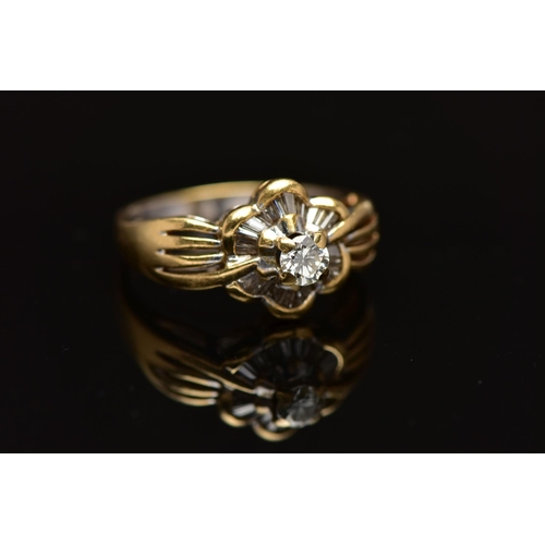 7 - A MODERN YELLOW METAL DIAMOND CLUSTER RING, set with a principal round brilliant cut diamond, within... 