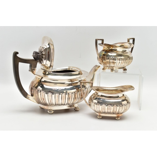 80 - AN EDWARDIAN WALKER & HALL THREE PIECE SILVER TEA SERVICE OF SHAPED RECTANGULAR FORM, the tea pot wi... 