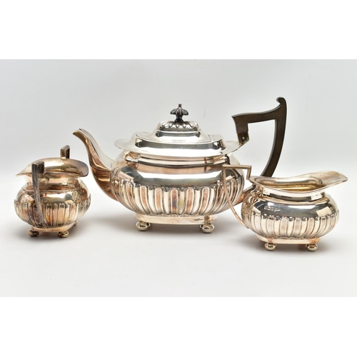 80 - AN EDWARDIAN WALKER & HALL THREE PIECE SILVER TEA SERVICE OF SHAPED RECTANGULAR FORM, the tea pot wi... 