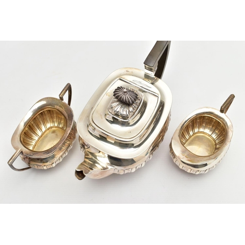 80 - AN EDWARDIAN WALKER & HALL THREE PIECE SILVER TEA SERVICE OF SHAPED RECTANGULAR FORM, the tea pot wi... 