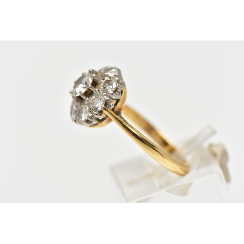 9 - A DIAMOND NINE STONE CLUSTER RING, set with a principal round brilliant cut diamond, surrounded by e... 