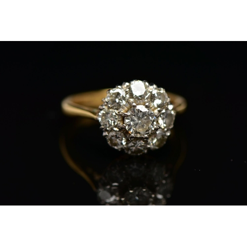 9 - A DIAMOND NINE STONE CLUSTER RING, set with a principal round brilliant cut diamond, surrounded by e... 