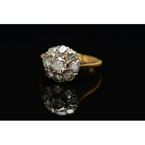 9 - A DIAMOND NINE STONE CLUSTER RING, set with a principal round brilliant cut diamond, surrounded by e... 