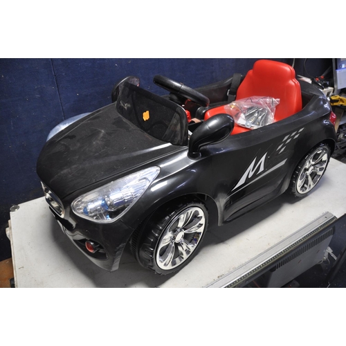 1052 - A CHILDRENS ELECTRIC RIDE ON CAR, with remote control capability, charger and instruction manual (UN... 